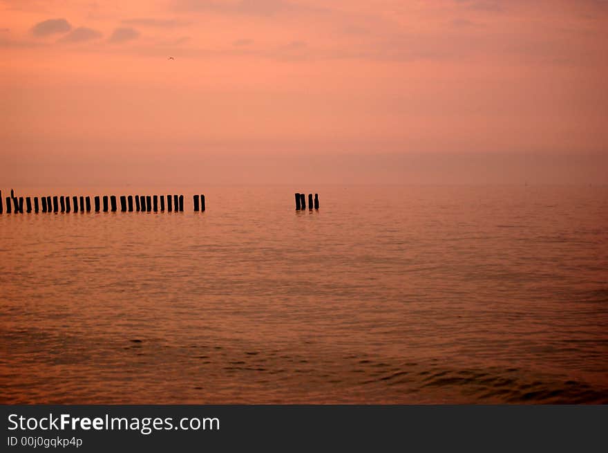 Beautiful sunrise on a beach with Storm Defences. Baltic Sea, Poland.