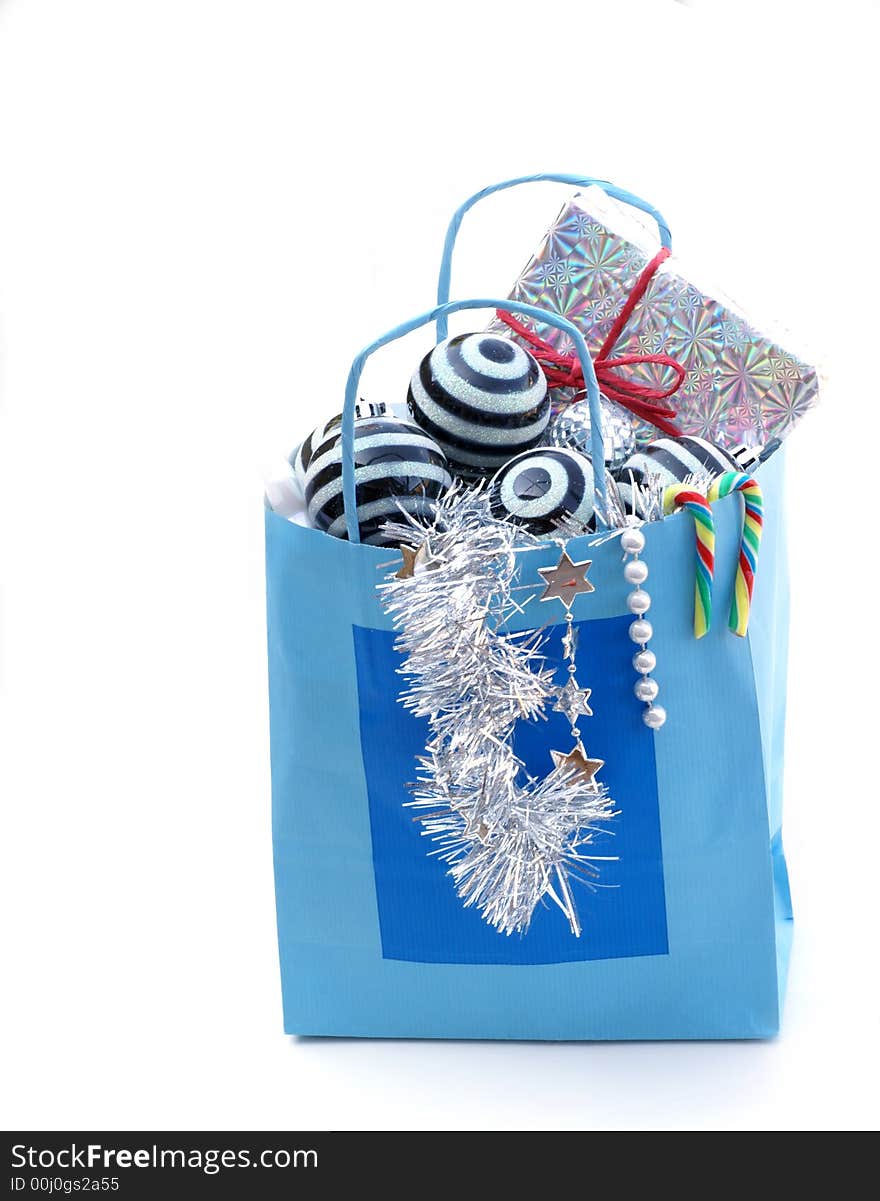 Christmas present and some ornaments in blue paper bag. Christmas present and some ornaments in blue paper bag.