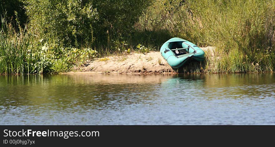 Rubber boat on sandy coast of the river. Rubber boat on sandy coast of the river