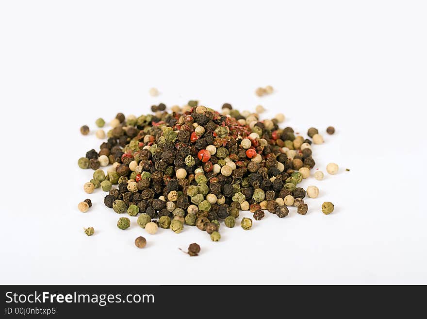 Multi color pepper seeds isolated over a white background