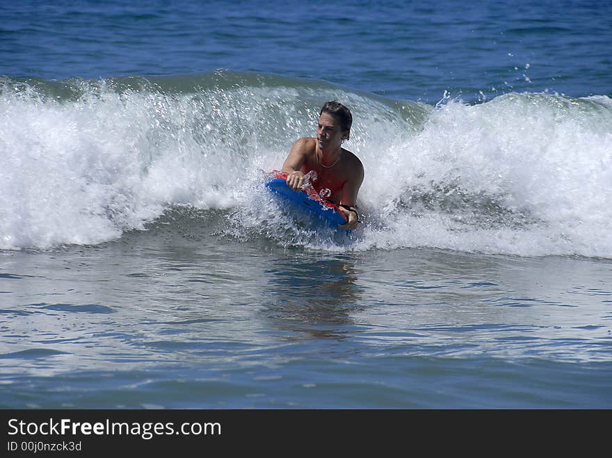 A man is riding on a buggyboard. A man is riding on a buggyboard