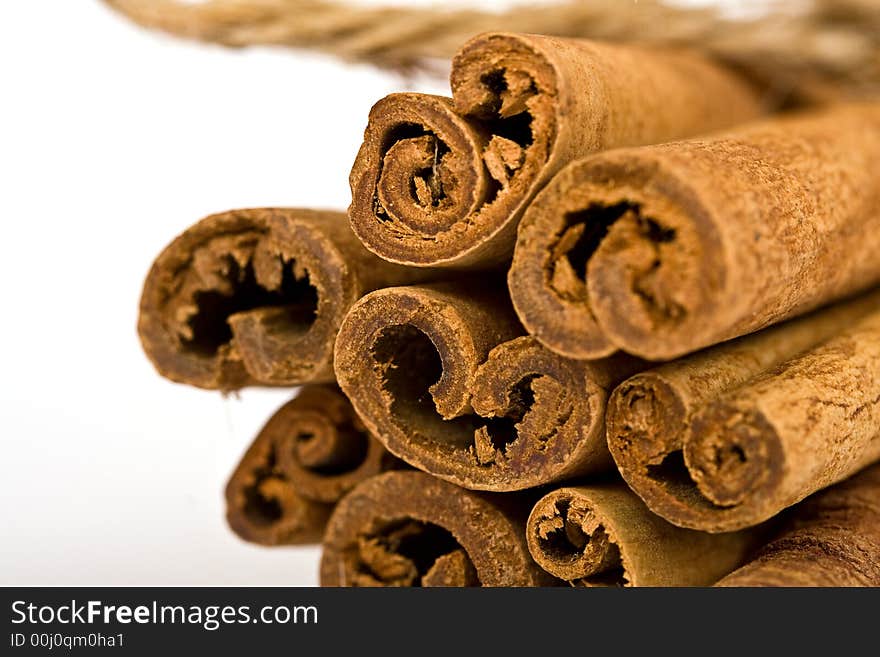 Cinnamon spicy sticks close-up isolated over a white background