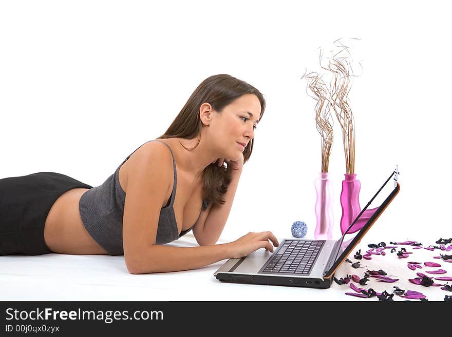 Pretty young woman with laptop on white background