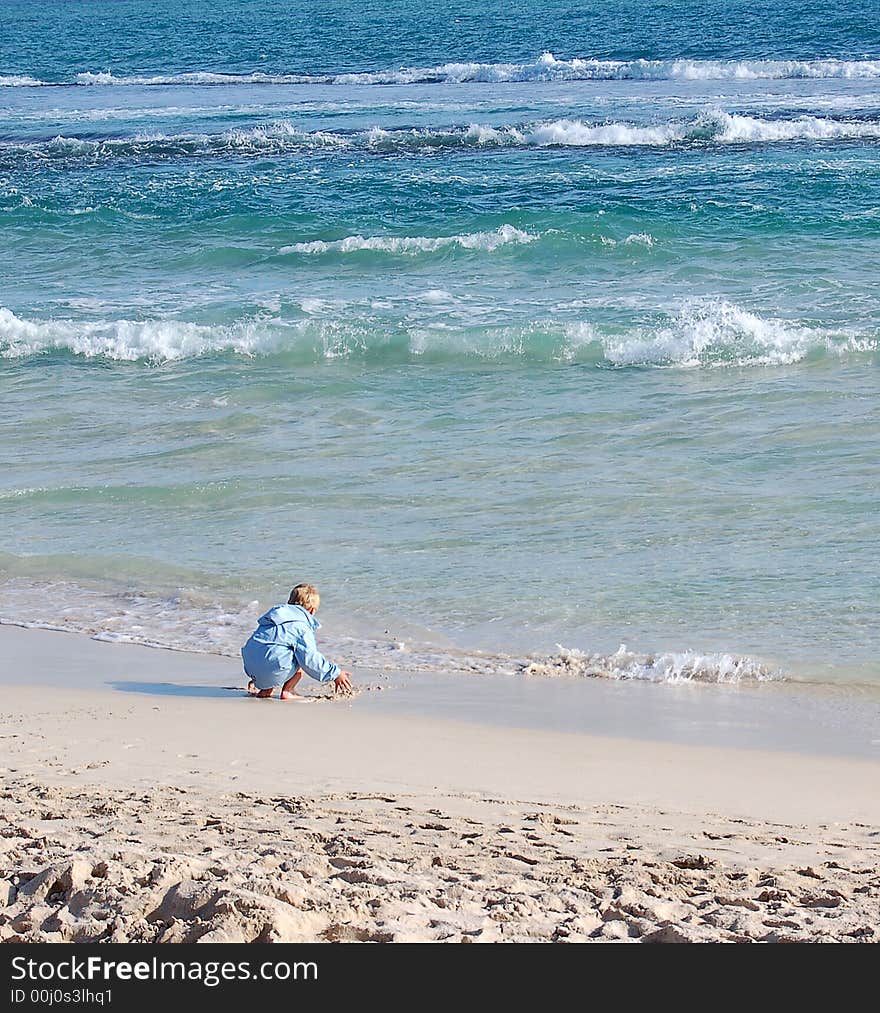 A small boy playing at the beach