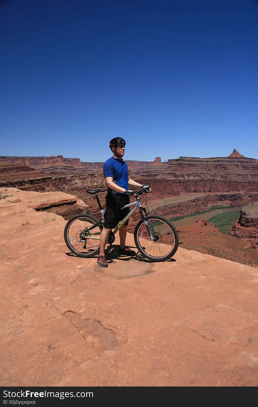 Mountain biker Canyonlands Nat’l Park overlooking Colorado River