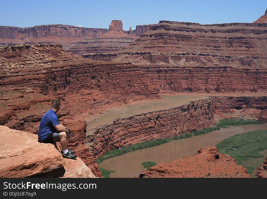 Mountain biker Canyonlands Nat’l Park overlooking Colorado River taking a breather. Mountain biker Canyonlands Nat’l Park overlooking Colorado River taking a breather