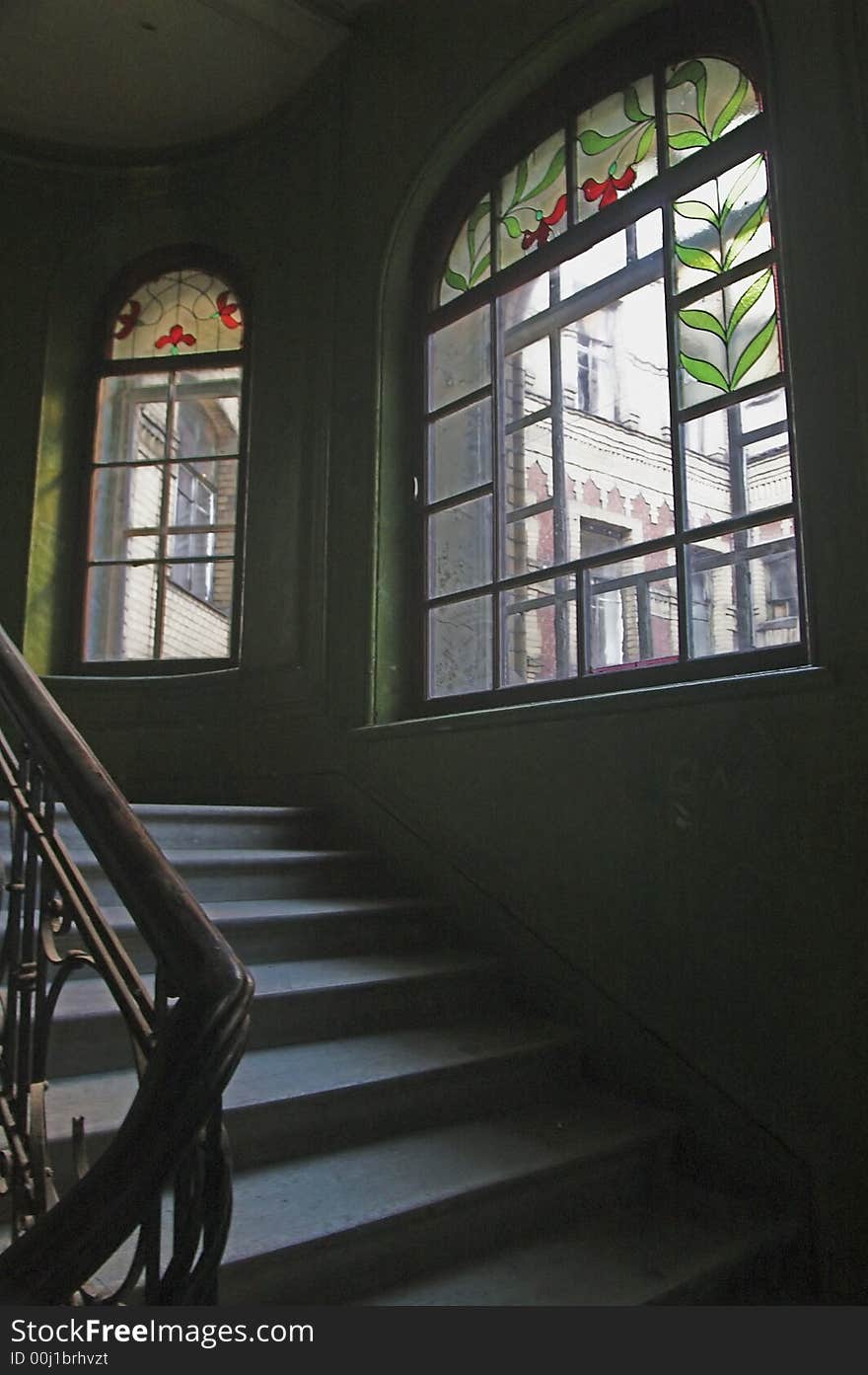 Stairway and stained-glass windows in old building. Stairway and stained-glass windows in old building