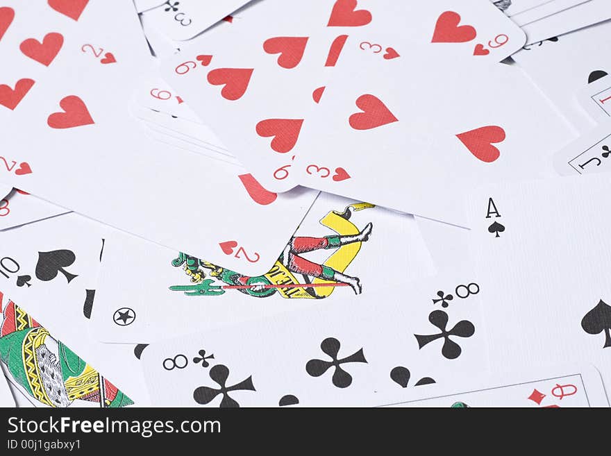 Set of playing cards are scattered on a table