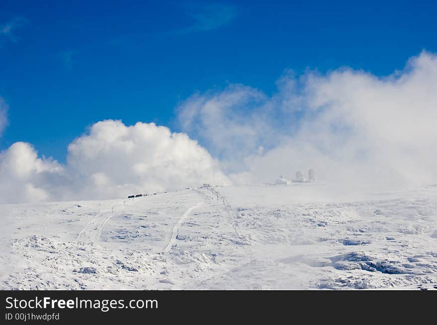 Snowy mountain top with blue sky. Snowy mountain top with blue sky