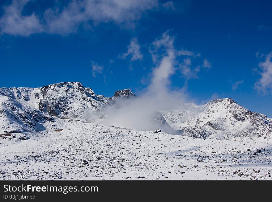 Snowy mountain top with blue sky