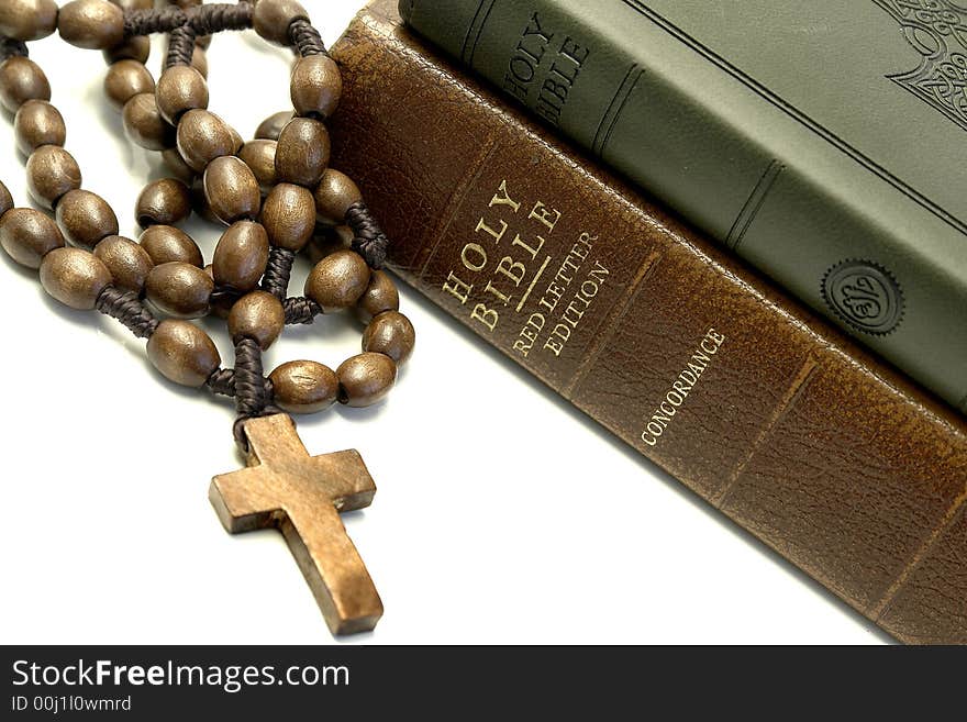 Bible and rosary on a white background. Bible and rosary on a white background