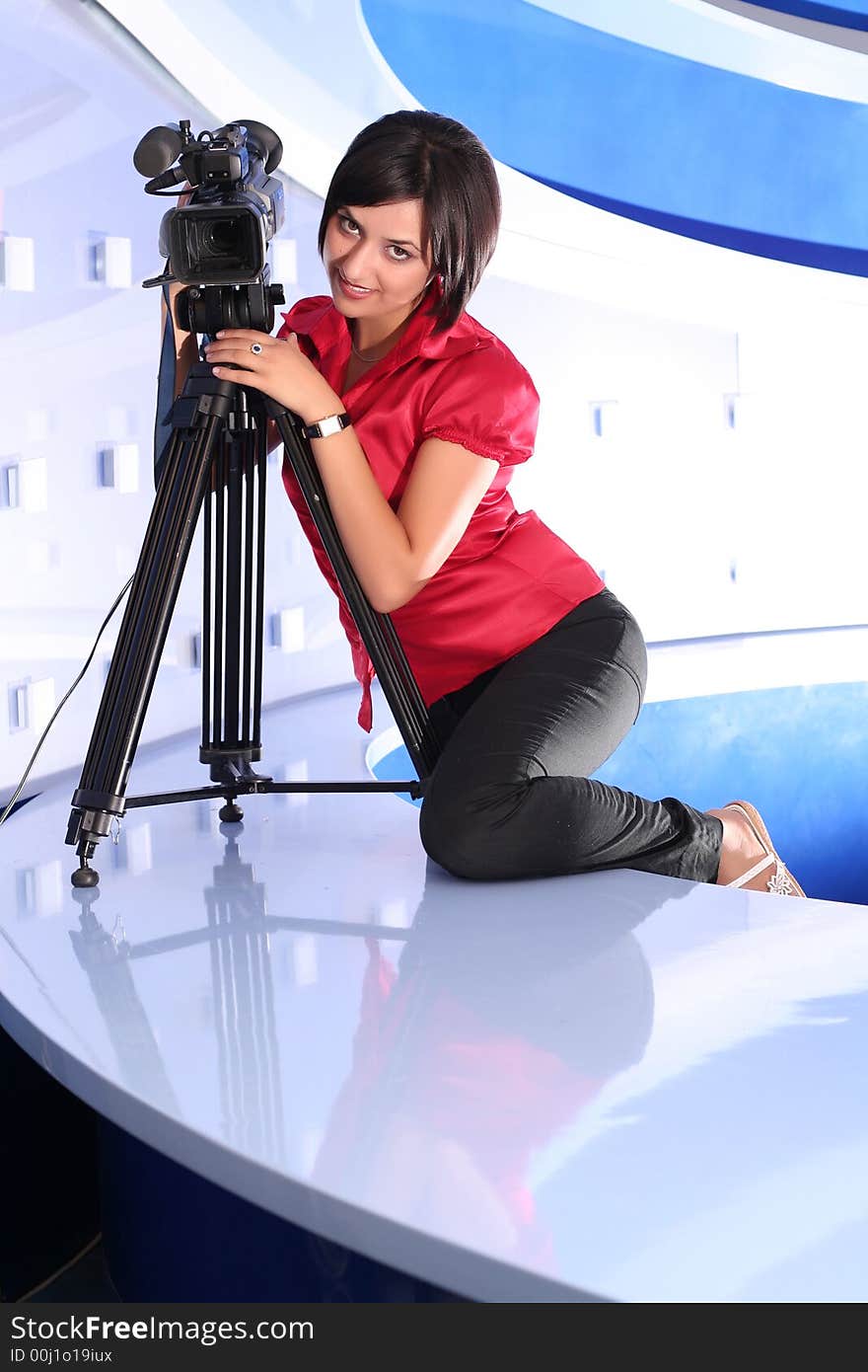 Young woman reporter posing like a photo model in TV studio. Young woman reporter posing like a photo model in TV studio