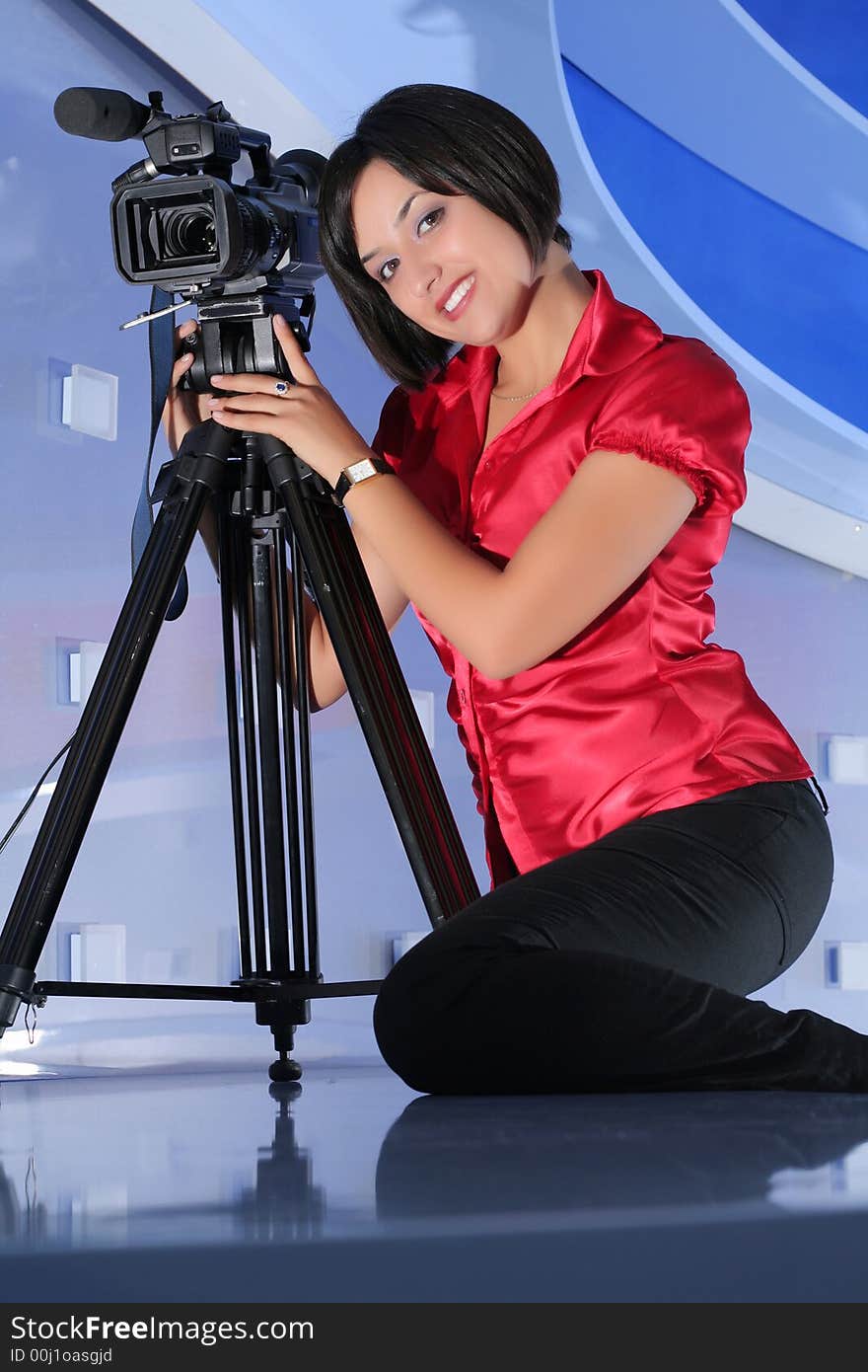 Young woman reporter posing like a photo model in TV studio. Young woman reporter posing like a photo model in TV studio