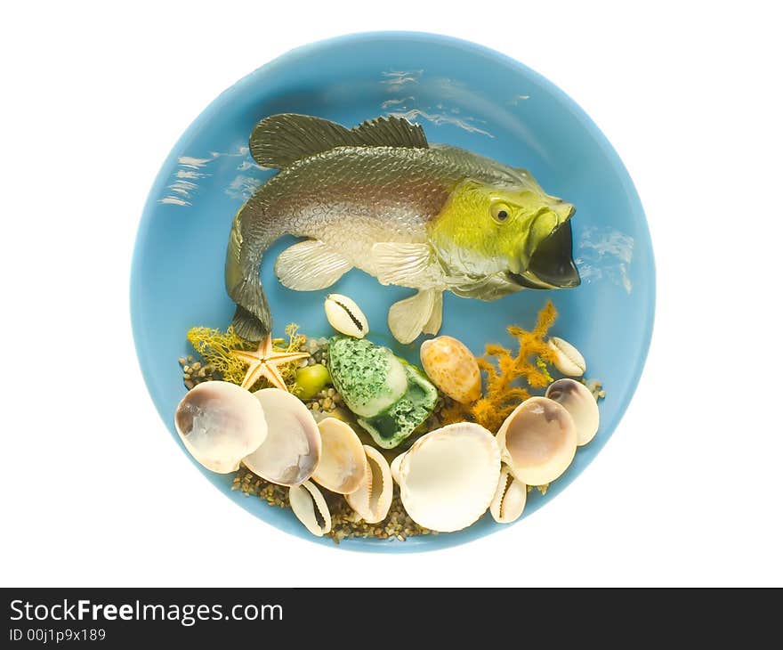 An isolated photo of a fish and shells on the plate. An isolated photo of a fish and shells on the plate