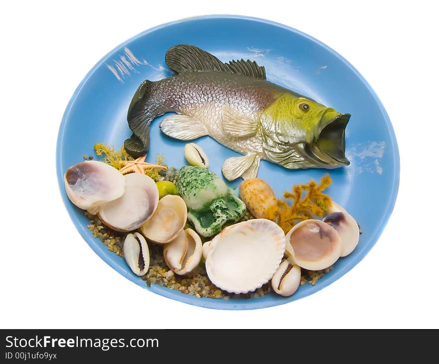 An isolated photo of a fish and shells on the plate. An isolated photo of a fish and shells on the plate