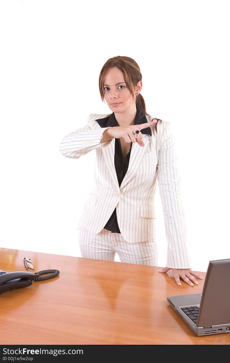 Beautiful young female executive pointing with her finger (dismissing an employee, for instance) - over a white background. Beautiful young female executive pointing with her finger (dismissing an employee, for instance) - over a white background