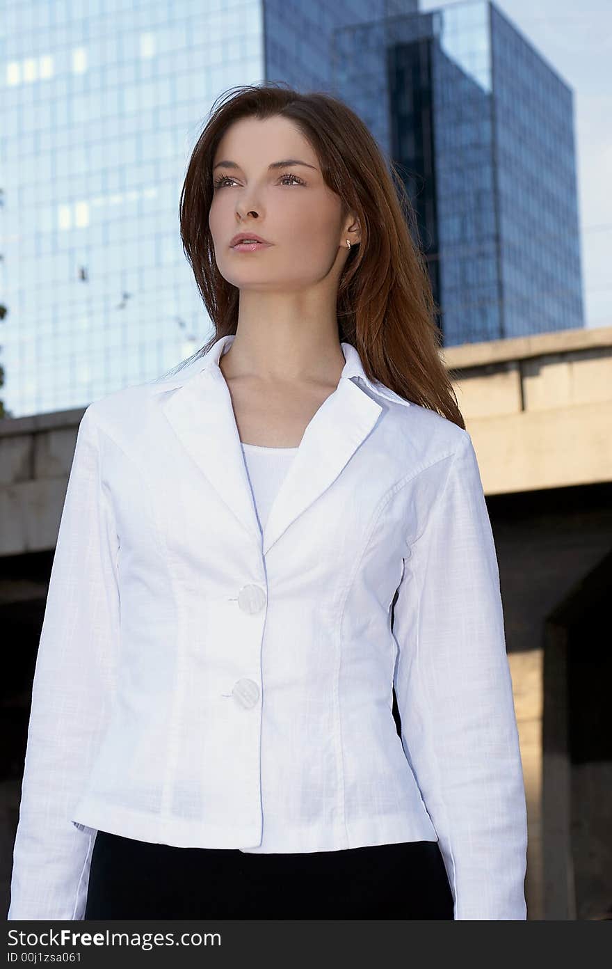 Young businesswoman in front of an office building