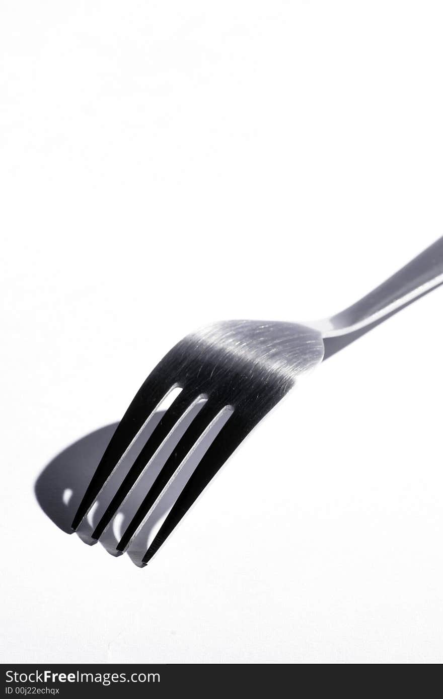 Top Os A Stainless Steel Fork With Shadow On A White Background