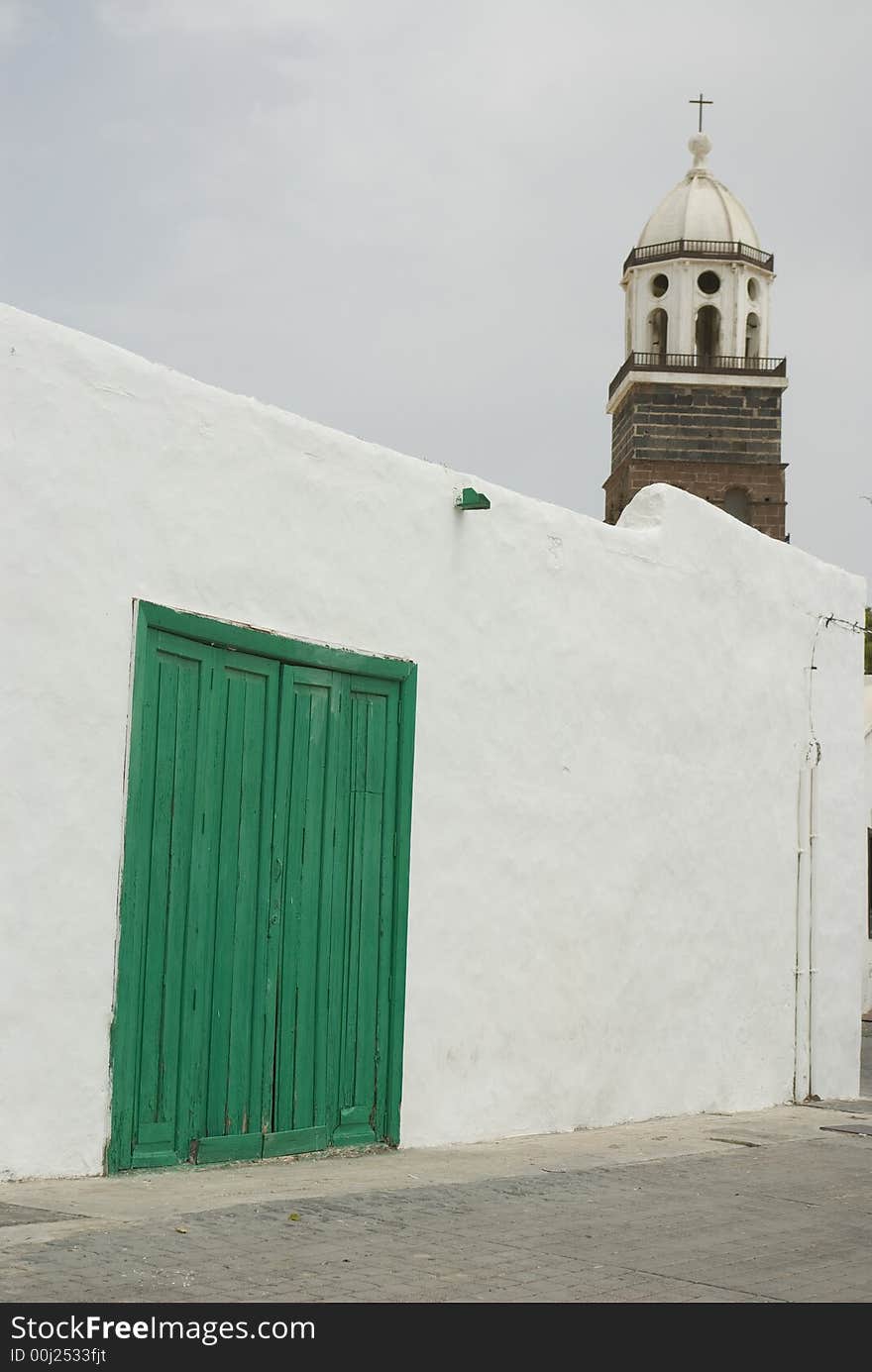 Old green door on a white wall