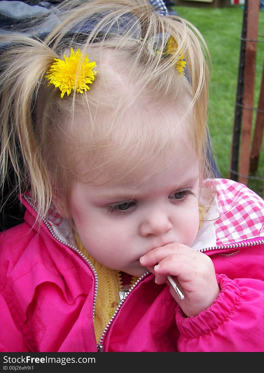 Little girl enjoying a sticky sucker. Little girl enjoying a sticky sucker