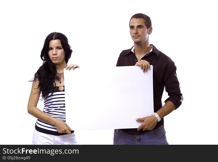 Young hispanic couple holding a blank banner - isolated over white. Young hispanic couple holding a blank banner - isolated over white