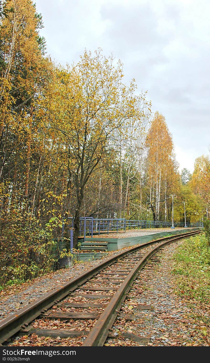 Old railroad track winding through forest. Old railroad track winding through forest