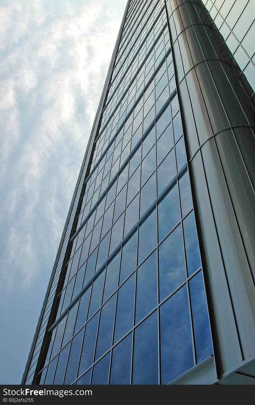 Fragment of a building from glass and metal on a background of the sky. Fragment of a building from glass and metal on a background of the sky