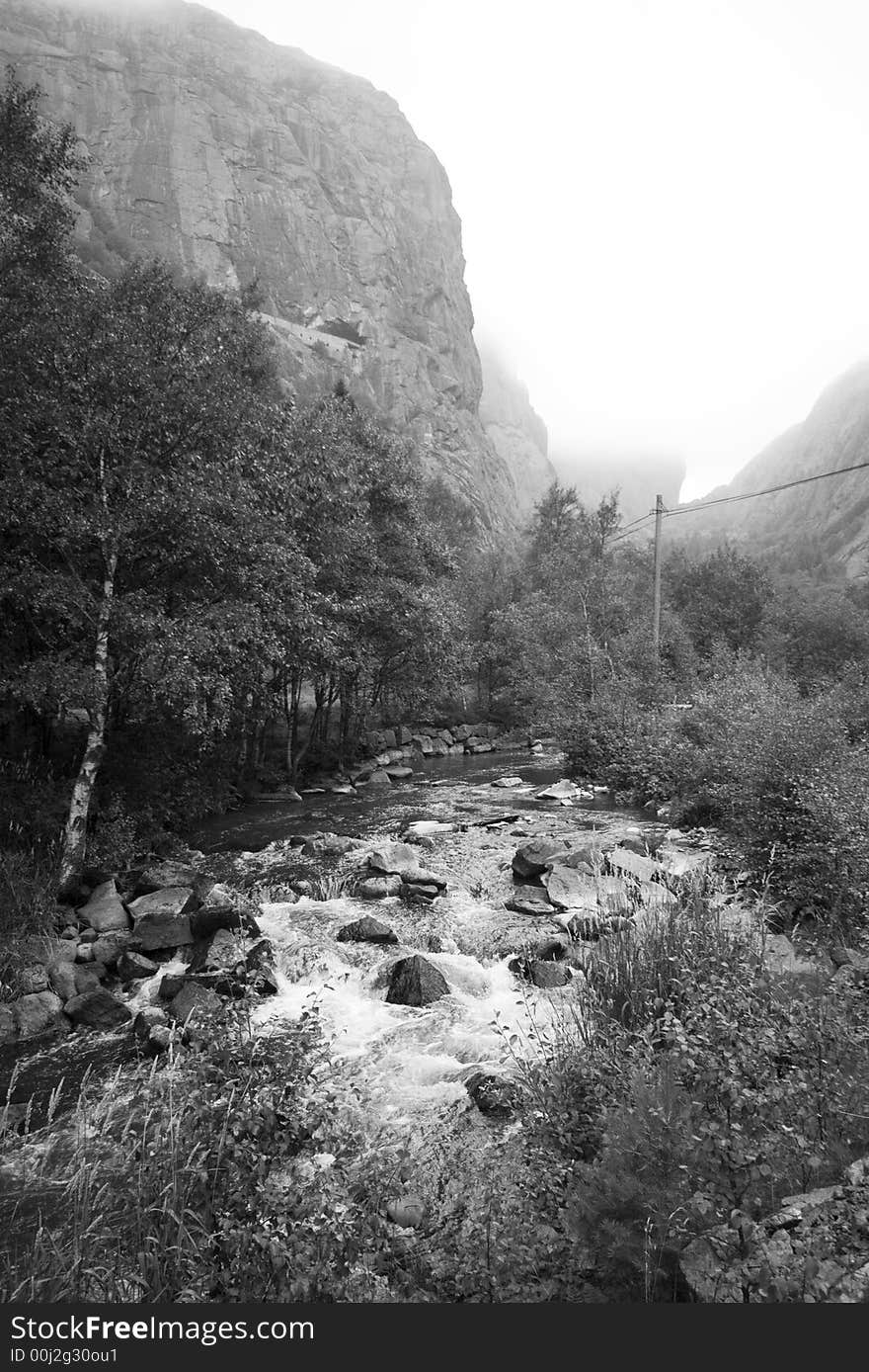 Massive Norwegian mountain and a river, foggy tops, monochrome photo.

<a href='http://www.dreamstime.com/beauty-of-norway-rcollection5045-resi208938' STYLE='font-size:13px; text-decoration: blink; color:#FF0000'><b>BEAUTY OF NORWAY COLLECTION »</b></a>. Massive Norwegian mountain and a river, foggy tops, monochrome photo.

<a href='http://www.dreamstime.com/beauty-of-norway-rcollection5045-resi208938' STYLE='font-size:13px; text-decoration: blink; color:#FF0000'><b>BEAUTY OF NORWAY COLLECTION »</b></a>