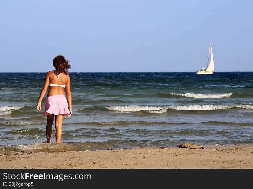 Girl and a boat at the seashore