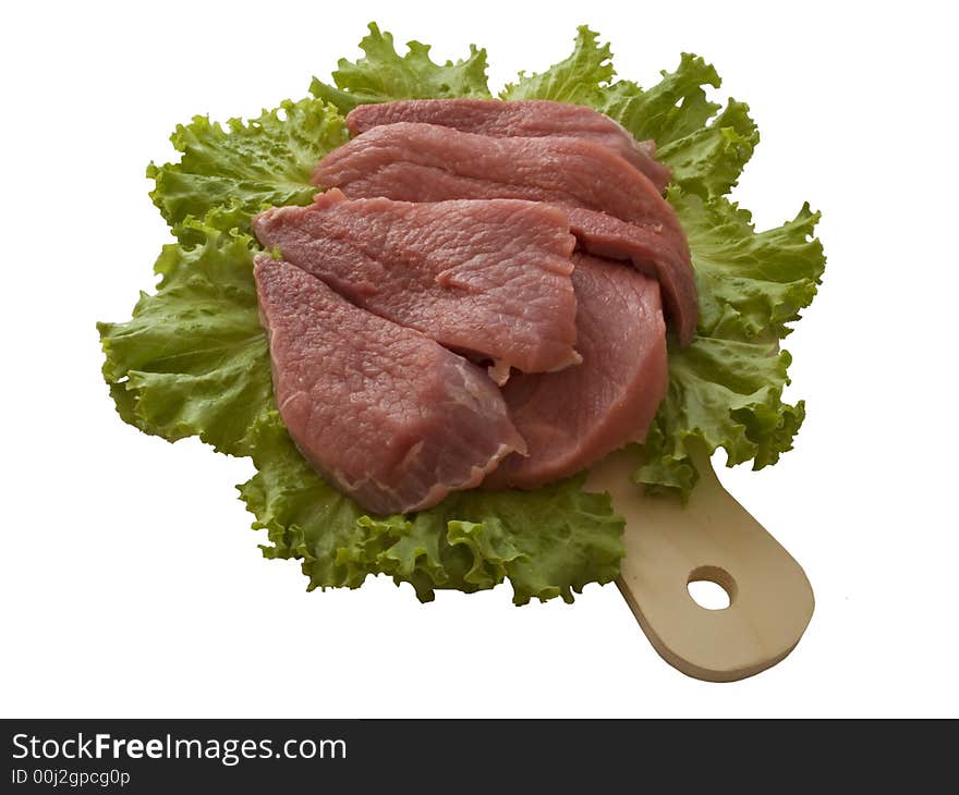 Fresh beef pieces lying on salad leaves. Fresh beef pieces lying on salad leaves