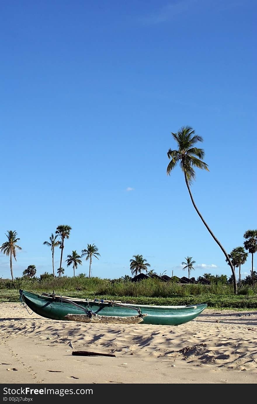 Boat on the sea shore in Uppuveli, Sri Lanka. Boat on the sea shore in Uppuveli, Sri Lanka