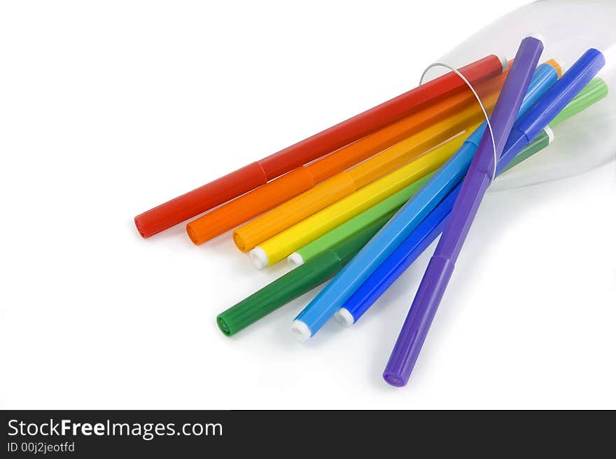 The coloredl pencils in a glass on the white background. The coloredl pencils in a glass on the white background