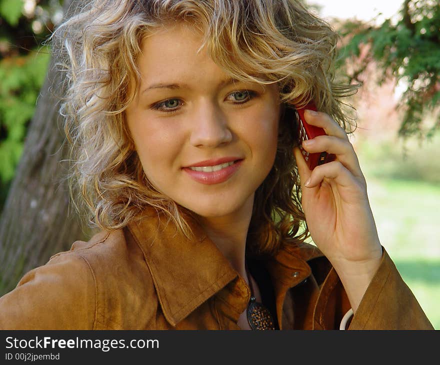 Girl with mobile in a park