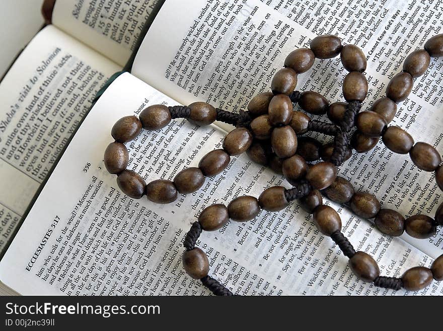 Bible and rosary on a white background. Bible and rosary on a white background