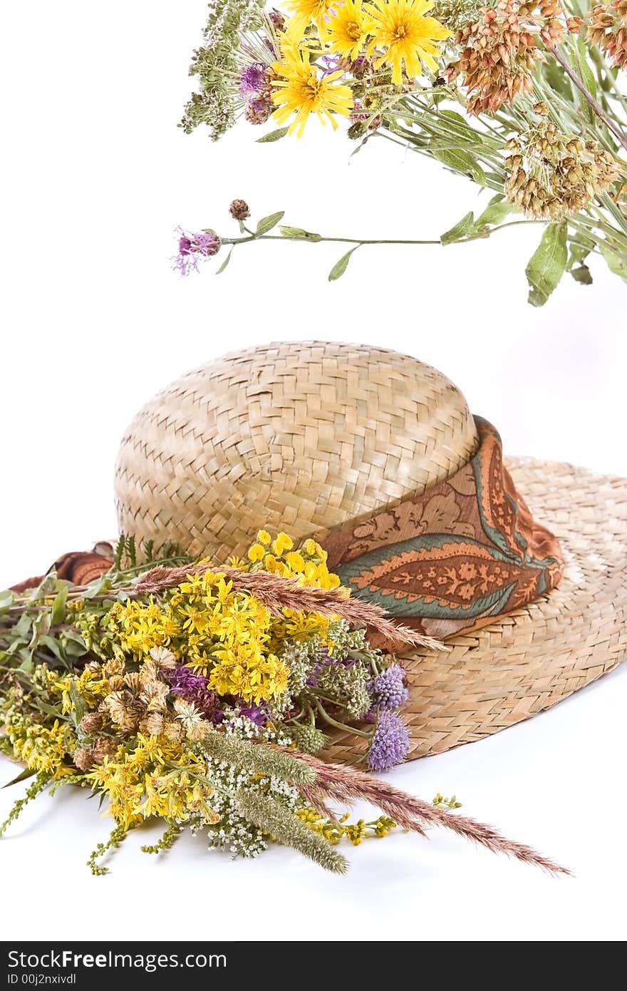 Straw hat and field flowers-retro beauty of a rural life