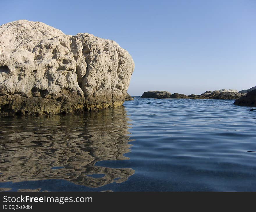 Rock reflected on the sea