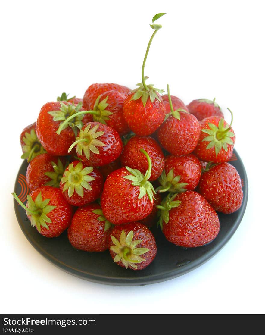 Plate with a strawberry on a white background. Plate with a strawberry on a white background.