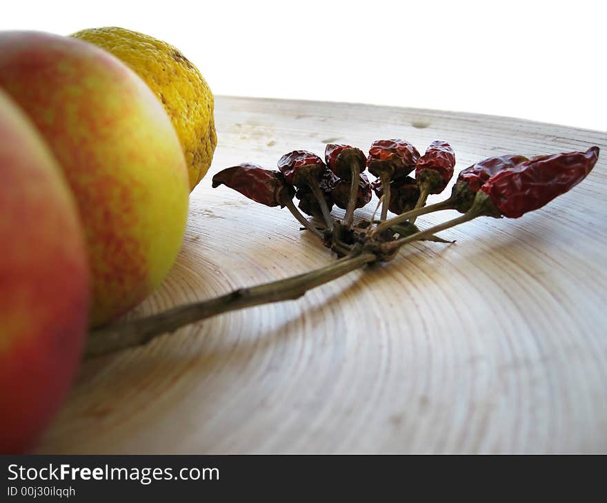 Dead nature: peaches, lemons and hot chili peppers