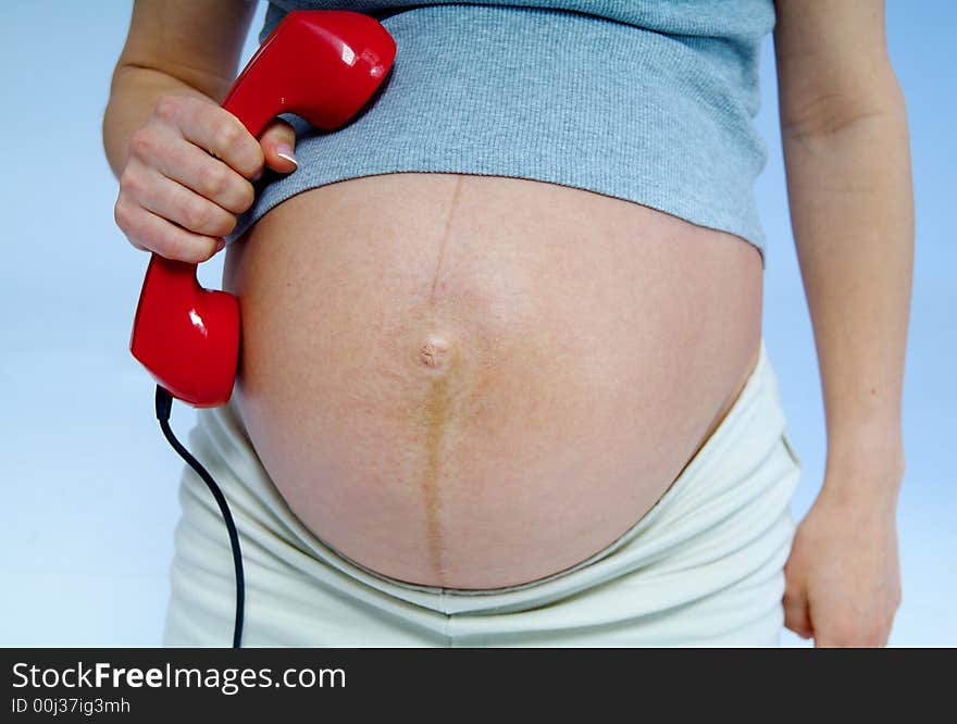 Pregnant woman with telephone on hand. Pregnant woman with telephone on hand