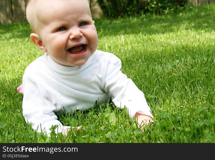 Little Baby Girl in grass in summer time