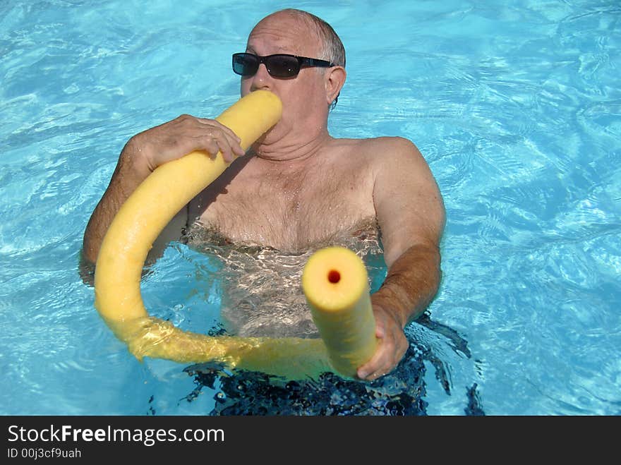 A man is having fun in the pool. A man is having fun in the pool