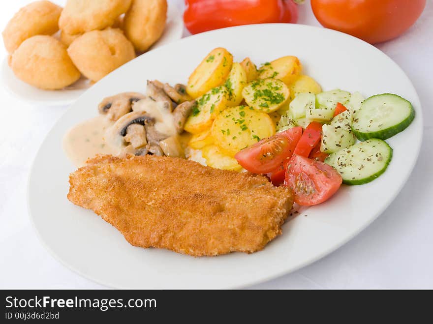 Viennese-milanese-steak with fried potatoes and salad