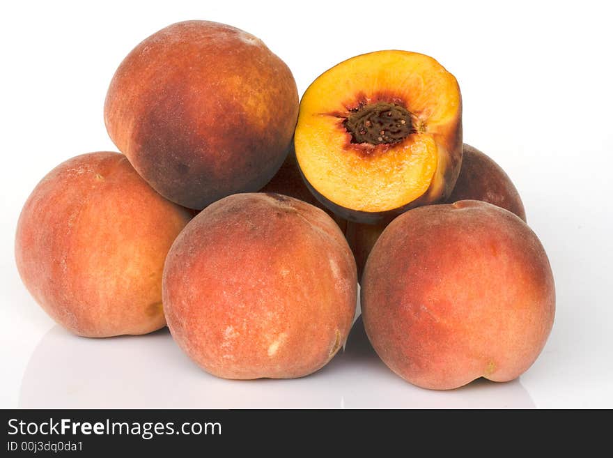 Fresh colored peaches on white background