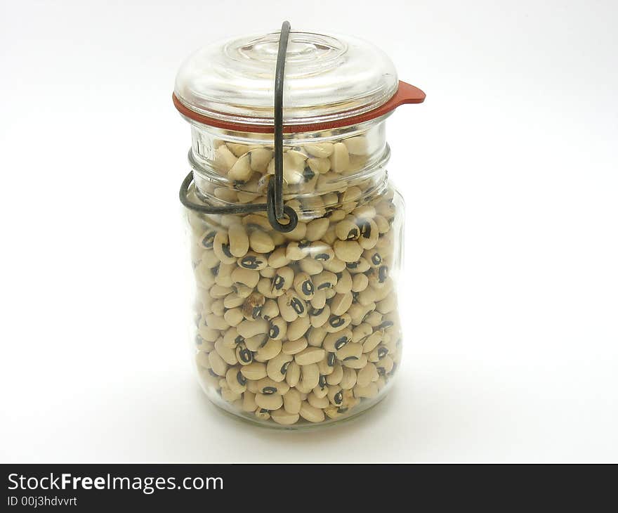 This is an old mason jar filled with beans photographed on a white background. This is an old mason jar filled with beans photographed on a white background.