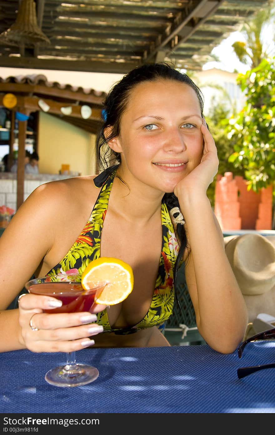 Young beautiful smiling woman with a cocktail. Young beautiful smiling woman with a cocktail