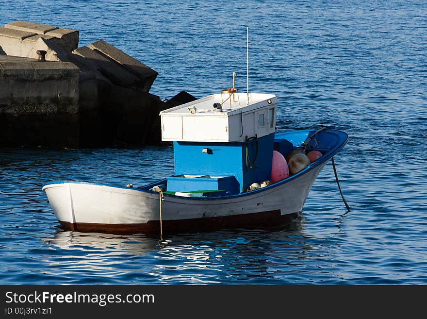 Fishing boat at anchor in a harbour. Fishing boat at anchor in a harbour