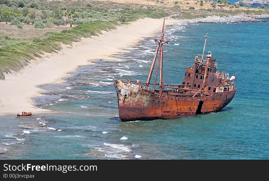 The rusty shipwreck on a coast near Gytheio, Greece. The rusty shipwreck on a coast near Gytheio, Greece