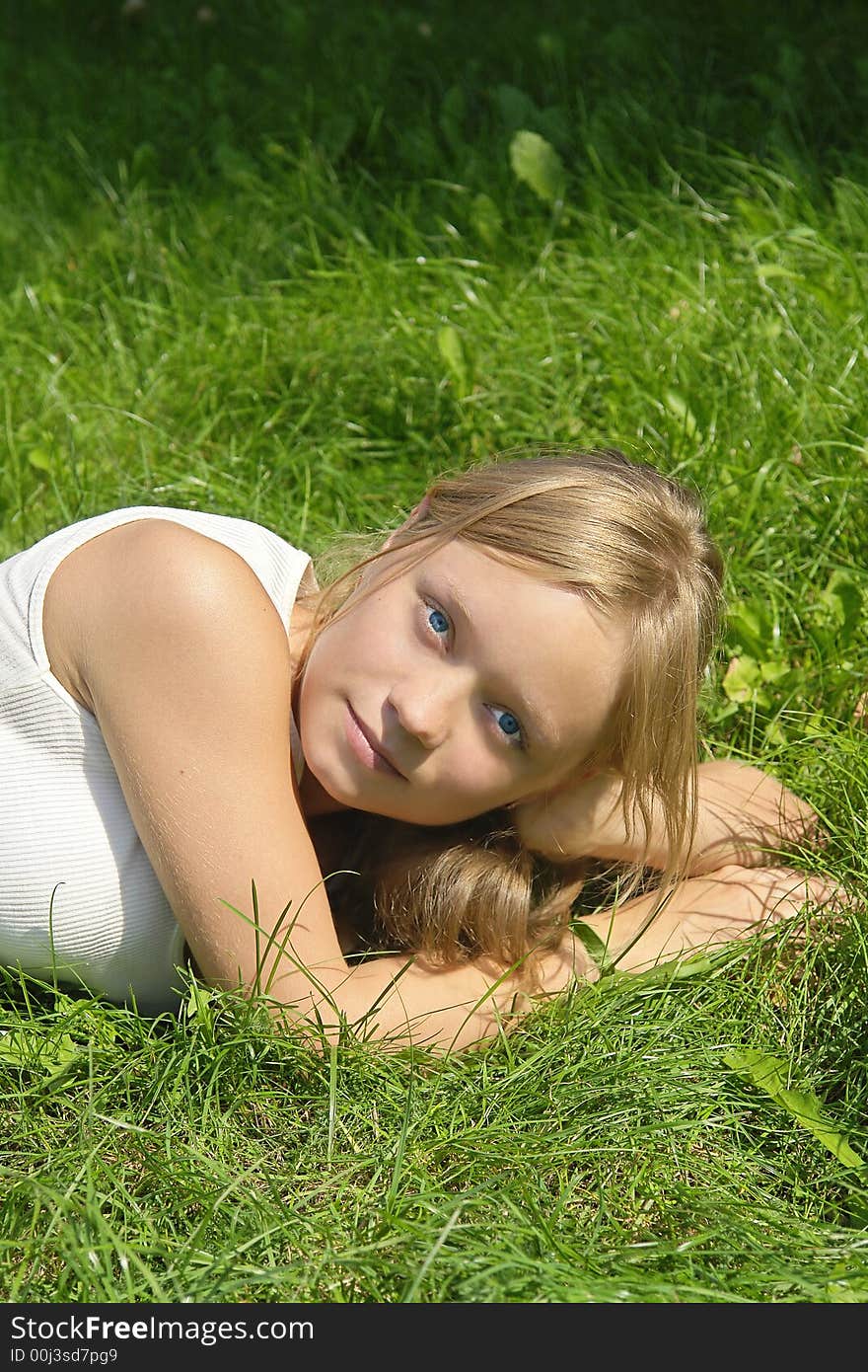 Young Girl Lying On The Grass