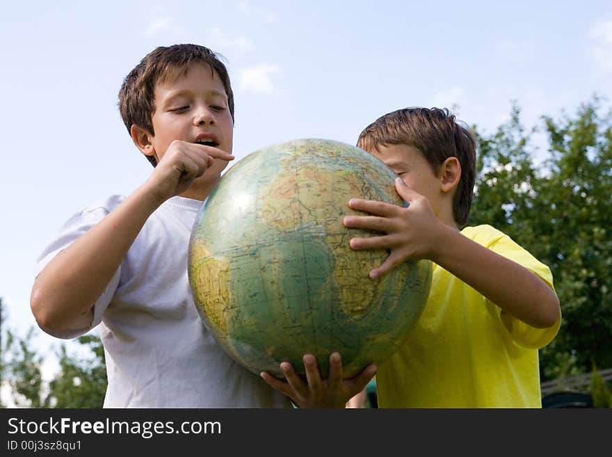 Brothers and globe in courtyard