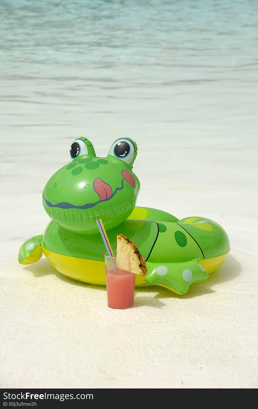 Happy frog is enjoying a cool drink by the pool. Happy frog is enjoying a cool drink by the pool